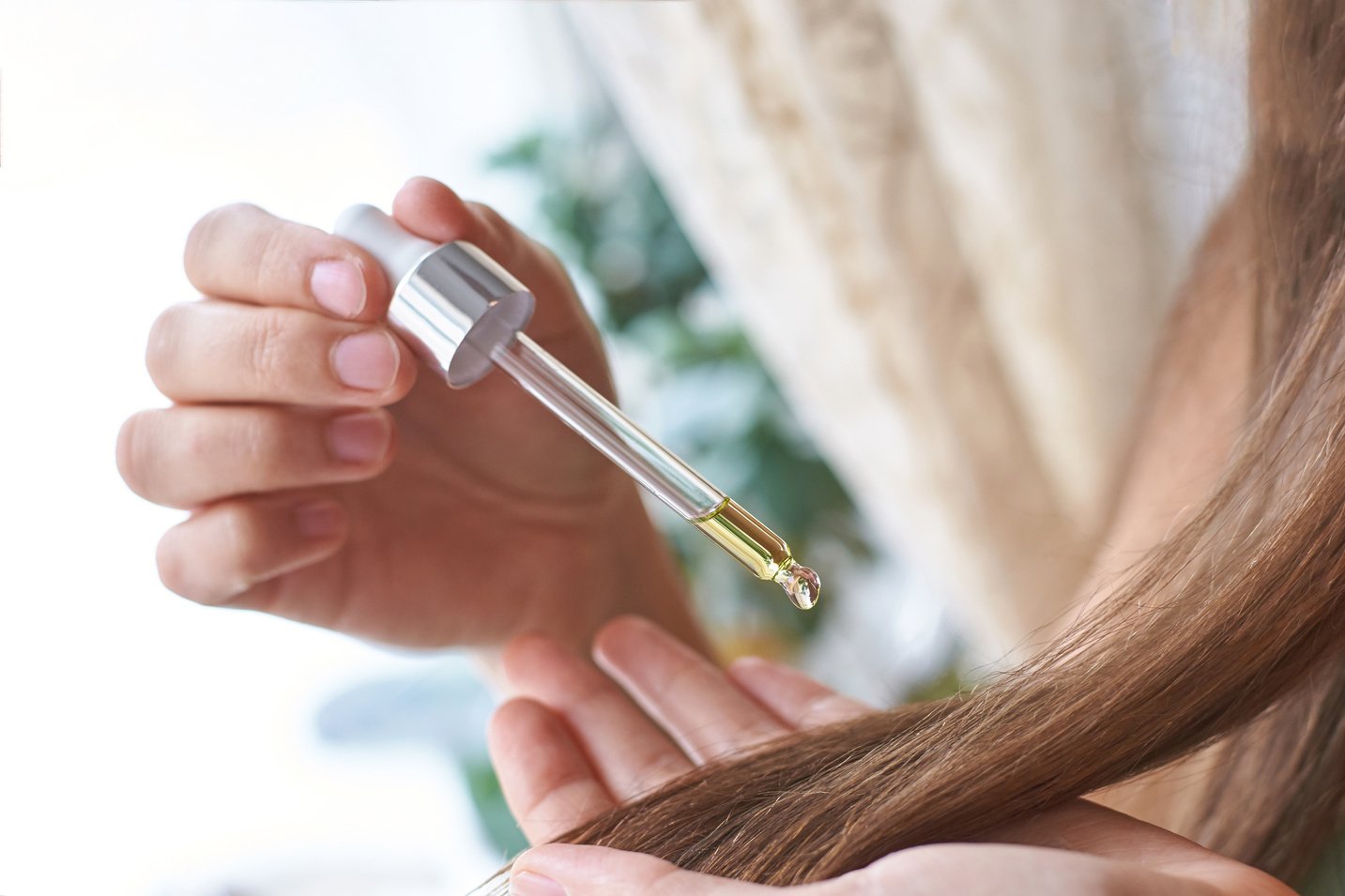 Girl Holding Dropper with Oil for Hair